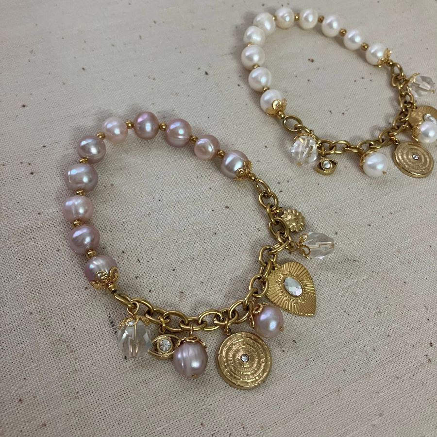 delicate bracelet blends baroque pearls with vintage inspired charms