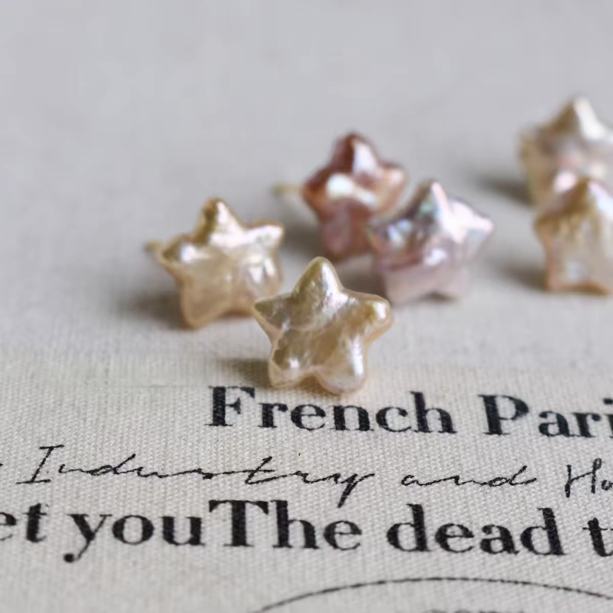 Iridescent pearl star studs