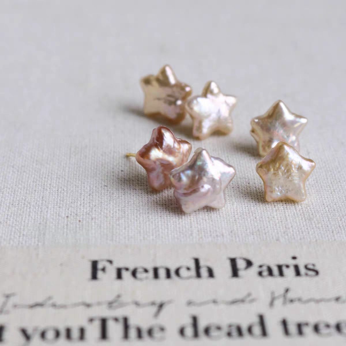 Iridescent pearl star studs